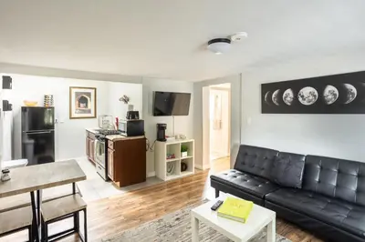 a living room with a black leather couch at Spacious Guest Suite Amazing Location in San Diego