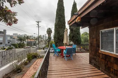 a wooden deck with a table and chairs and an umbrella at Spacious Guest Suite Amazing Location in San Diego