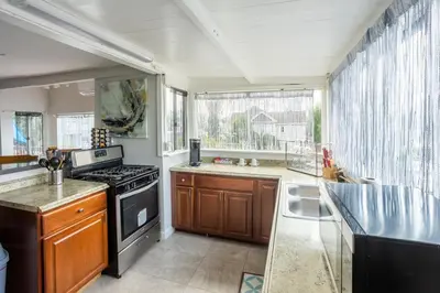 a kitchen with a stove top oven next to a window at Big Studio with Ocean View max 6 sleepers in San Diego