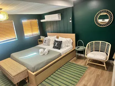 a small bedroom with a bed and a chair at COZY Studio in Downtown San Diego in San Diego
