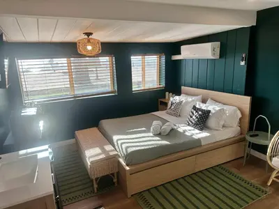 a bedroom with a bed with green walls at COZY Studio in Downtown San Diego in San Diego