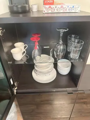 a shelf with plates and cups and other glass items at Special Studio in Center of San Diego in San Diego