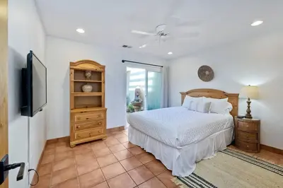 a bedroom with a bed and a flat screen tv at Great Group Retreat! Hacienda Decor, Spacious Floor Plan, Private Backyard in Carlsbad