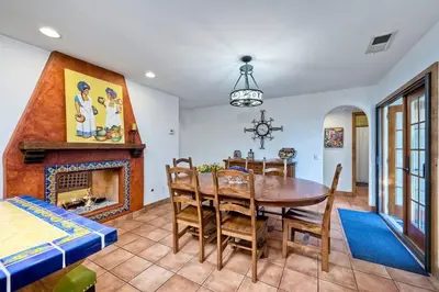 a dining room with a table and a fireplace at Great Group Retreat! Hacienda Decor, Spacious Floor Plan, Private Backyard in Carlsbad