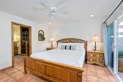 a bedroom with a bed and a ceiling fan at Great Group Retreat! Hacienda Decor, Spacious Floor Plan, Private Backyard in Carlsbad