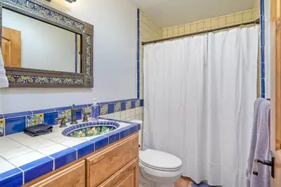 a bathroom with a sink and a toilet and a mirror at Great Group Retreat! Hacienda Decor, Spacious Floor Plan, Private Backyard in Carlsbad