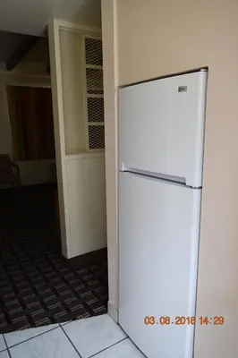 a white refrigerator in a room with a hallway at Stanlunds Inn and Suites in Borrego Springs