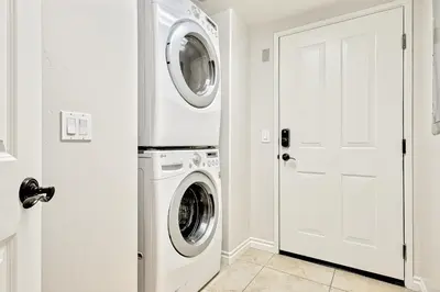 a white laundry room with a washer and dryer at Crown Point Views Home in San Diego