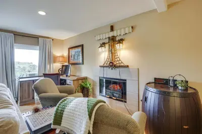 a living room with a fireplace and a couch at Hot Tub and Balcony Rainbow Retreat Near Wineries! in Fallbrook