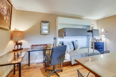 a bedroom with a desk and a bunk bed at Hot Tub and Balcony Rainbow Retreat Near Wineries! in Fallbrook