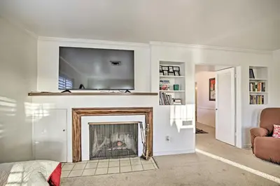 a living room with a fireplace with a flat screen tv at Quaint La Mesa Home with Beautiful Sunsets! in La Mesa