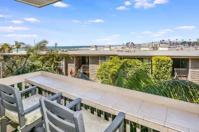 a balcony with a table and chairs and the beach at E105 - Seascape Stay - On-the-Sand in Oceanside
