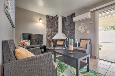 a living room with a table and chairs and a television at Relaxing Poway Apt with Patio Near Parks and Wineries! in Poway