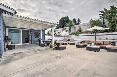 a patio with couches and tables and umbrellas at Relaxing Poway Apt with Patio Near Parks and Wineries! in Poway