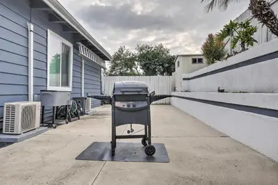 a barbecue grill on a sidewalk next to a house at Relaxing Poway Apt with Patio Near Parks and Wineries! in Poway