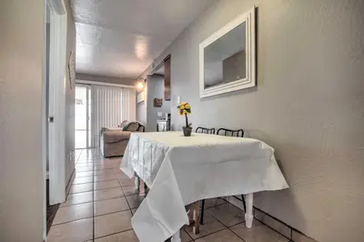 a dining room with a table with a white table cloth at Relaxing Poway Apt with Patio Near Parks and Wineries! in Poway