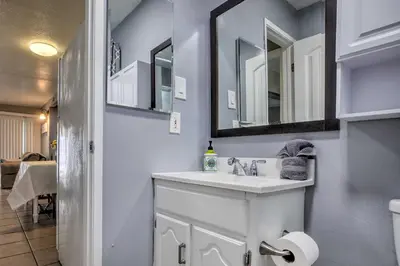a bathroom with a sink and a mirror at Relaxing Poway Apt with Patio Near Parks and Wineries! in Poway