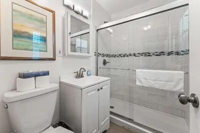 a bathroom with a shower and a toilet and a sink at La Jolla Beach Casita in San Diego