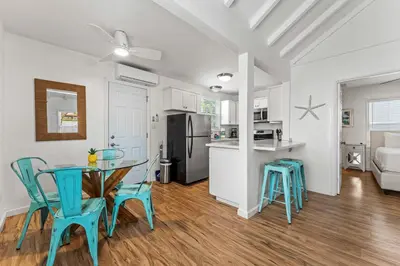a kitchen and dining room with a table and chairs at La Jolla Beach Casita in San Diego