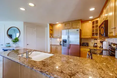 a kitchen with a sink and a refrigerator at Cohasset Getaway Unit #3 in San Diego
