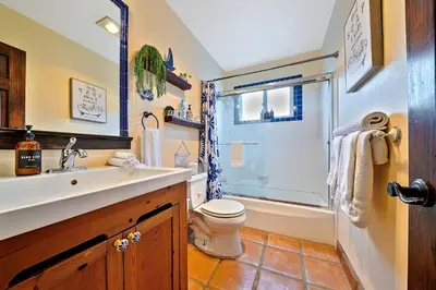 a bathroom with a sink and a toilet and a shower at Canyon Palms in San Diego