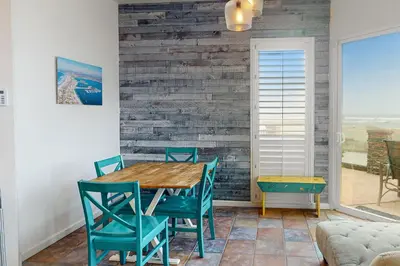 a dining room with a wooden table and chairs at Santa Barbara Unit #2 in San Diego