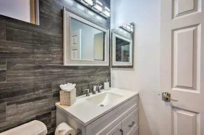 a bathroom with a white sink and a mirror at Torrey Spa Suite Modern San Diego Studio! in San Diego