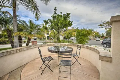 a patio with a table and chairs on a balcony at Torrey Spa Suite Modern San Diego Studio! in San Diego