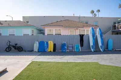 a row of surfboards lined up against a fence at BEACHFRONT COTTAGE UPPER UNIT in Oceanside