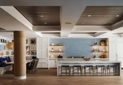 a kitchen with a table and some chairs at Shore House at The Del, LXR Hotels & Resorts in San Diego