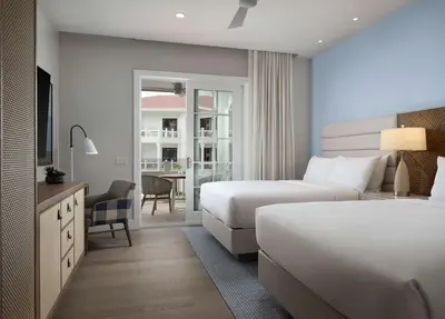 a hotel room with two beds and a desk with a chair at Shore House at The Del, LXR Hotels & Resorts in San Diego