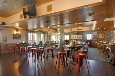 a restaurant with tables and stools in a room at Palm Canyon Hotel and RV Resort in Borrego Springs