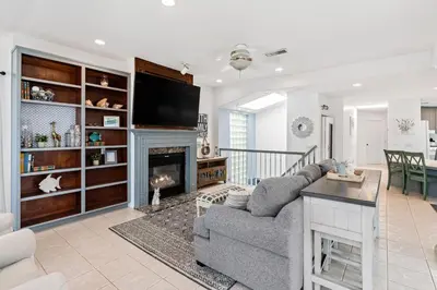 a living room with a couch and a fireplace at The Strand Oasis in Oceanside
