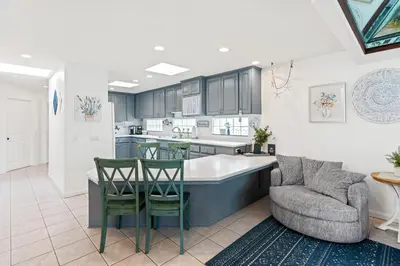 a kitchen with a couch and a table and chairs at The Strand Oasis in Oceanside