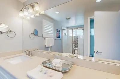 a bathroom with a sink and a large mirror at Ingraham Delight Pacific Beach in San Diego