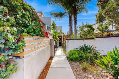 a walkway in front of a house with a fence at Ingraham Delight Pacific Beach in San Diego