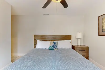a bedroom with a bed with a ceiling fan at Rise and Shine in Newport Beach
