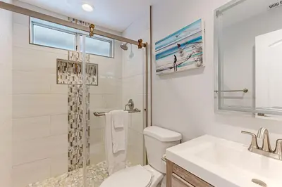 a bathroom with a toilet and a sink and a shower at Rise and Shine in Newport Beach