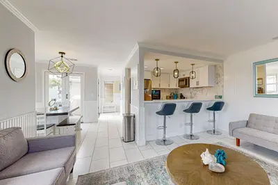 a living room with a couch and a table at Rise and Shine in Newport Beach
