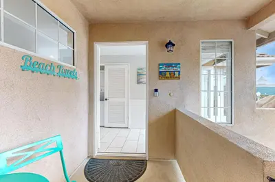 a door leading to a beach resort with a view at Rise and Shine in Newport Beach