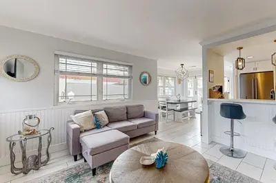 a living room with a couch and a table at Rise and Shine in Newport Beach