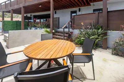 a wooden table and chairs on a patio at Contemporary Ocean Sunset Views with Firepit Pt Loma close to PLNU in San Diego
