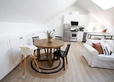 a kitchen and living room with a table and a couch at Coastal, Elegant, Modern, King Bed in San Diego