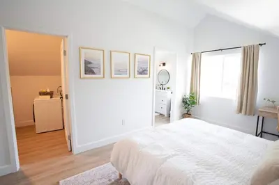 a white bedroom with a bed and a window at Coastal, Elegant, Modern, King Bed in San Diego