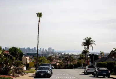 a street with cars parked on a street with a palm tree at Coastal, Elegant, Modern, King Bed in San Diego