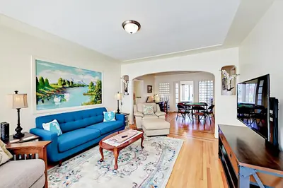 a living room with a blue couch and a table at Little Italy Charmer in San Diego