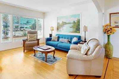 a living room with a blue couch and a table at Little Italy Charmer in San Diego