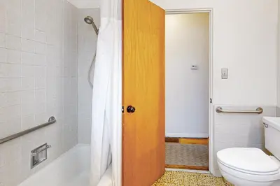 a bathroom with a toilet and a tub and a sink at Little Italy Charmer in San Diego