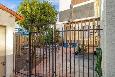 a gate in front of a building with a playground at Little Italy Charmer in San Diego
