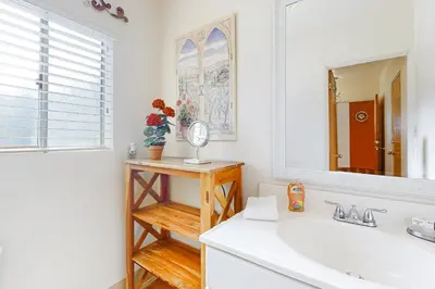 a bathroom with a sink and a mirror at Little Italy Charmer in San Diego
